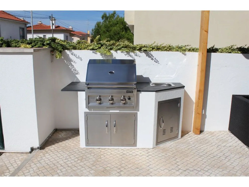 Sunstone vented access door installed on an outdoor kitchen island with built-in grill and sink – stainless access panel adds clean service access and ventilation.