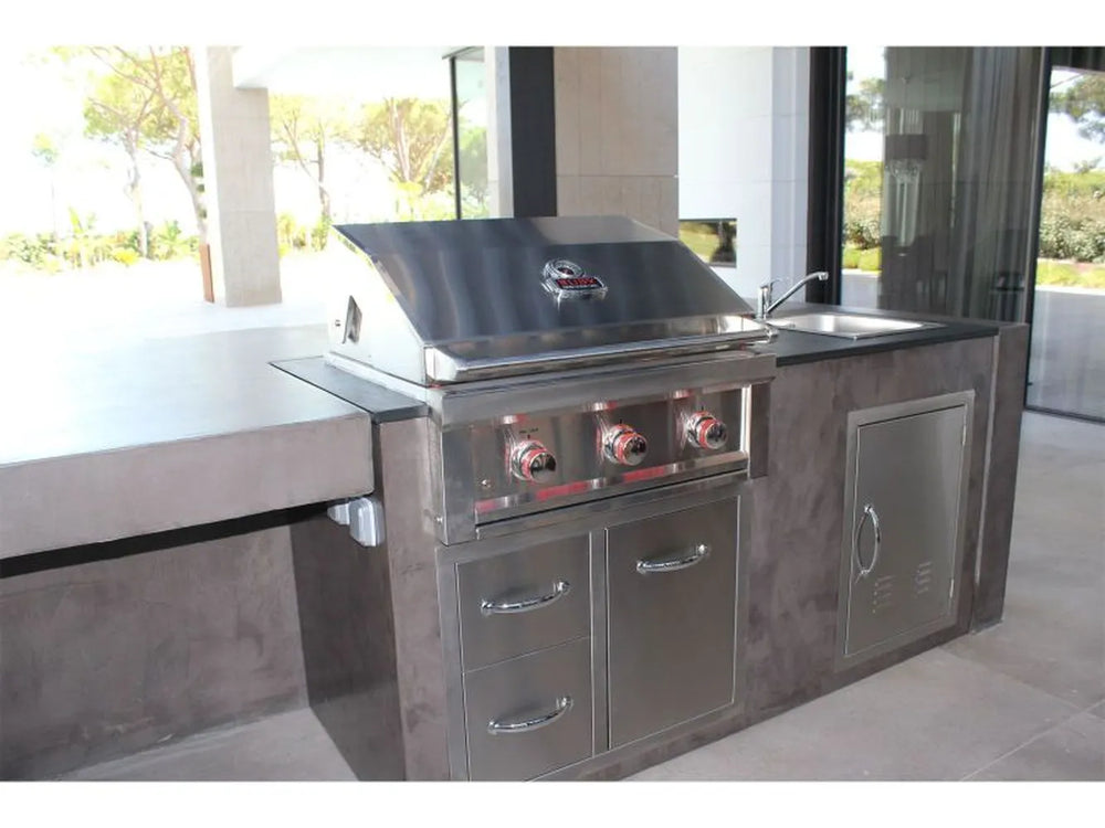 Outdoor kitchen island with built-in stainless grill and Sunstone A-LPCDD30 drawers and tank tray combo installed below.