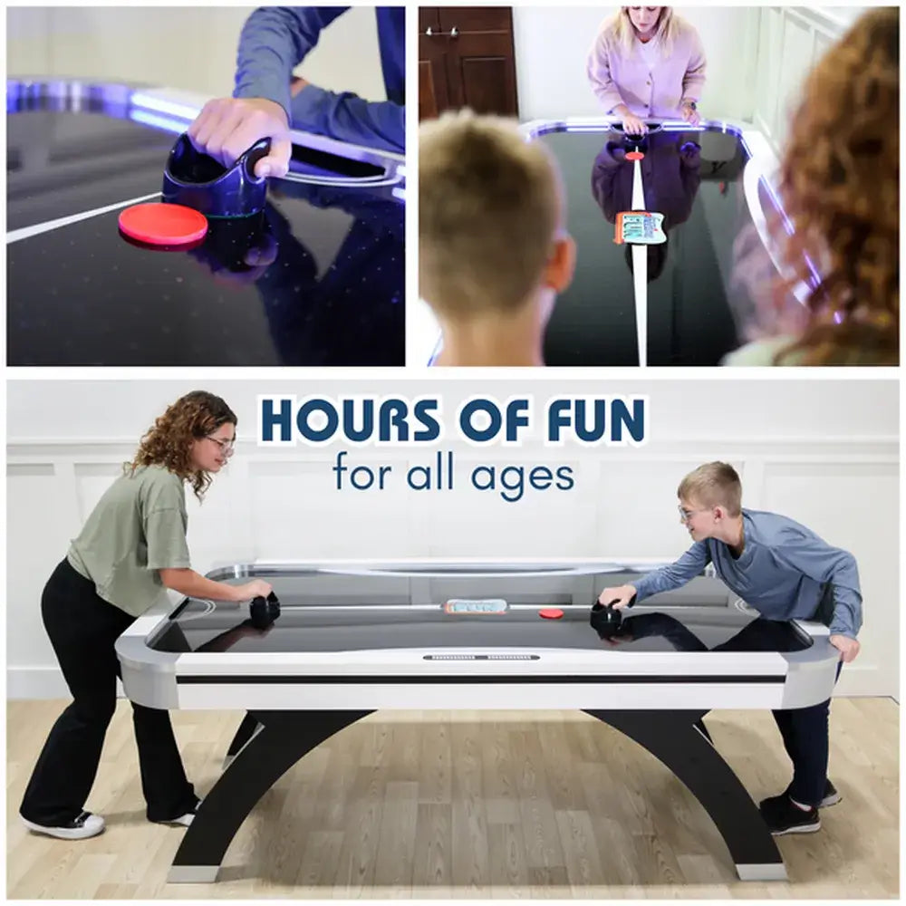 People playing air hockey game, showing close-up of puck and striker action and family fun