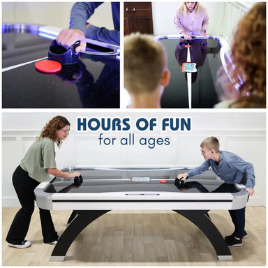 People playing air hockey game, showing close-up of puck and striker action and family fun