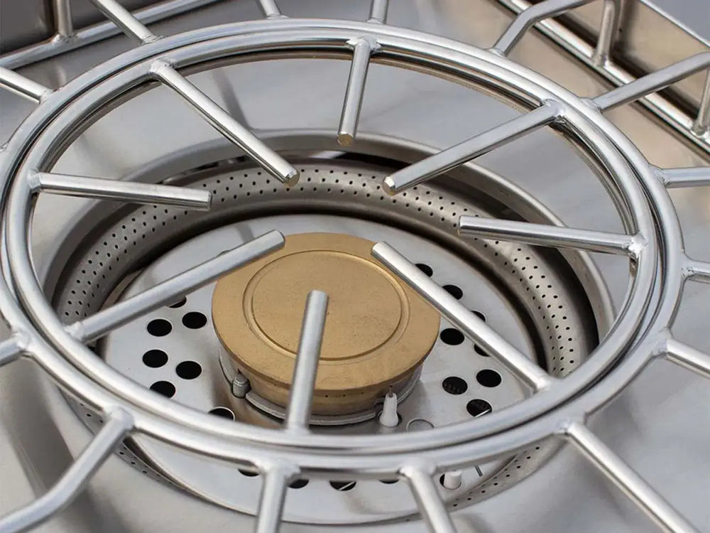 Close-up detail of the heavy-duty stainless steel grate and brass burner of the American Made Grills ESTPB2