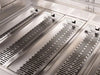 Stainless steel flame tamers inside professional gas grill