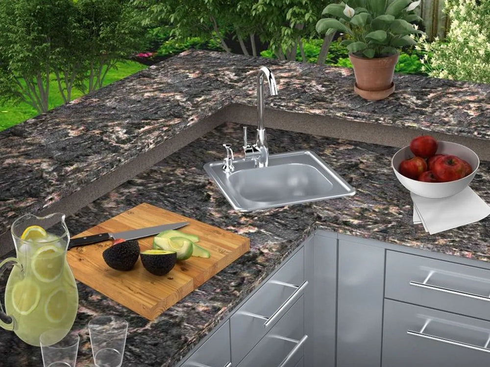 Sunstone A-SS17 outdoor kitchen drop-in sink installed in granite countertop with hot/cold faucet, prep area for washing produce and tools.
