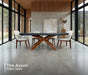 Axiom designer poker table in modern glass home with upholstered chairs and wood pedestal base