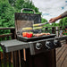 Broil King Crown 310 Shadow gas grill cooking on outdoor deck