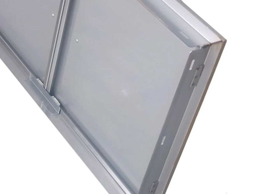 Close-up of Sunstone BA-DD42 304 stainless steel access door frame showing hinge side, mounting flange, and brushed finish detail.