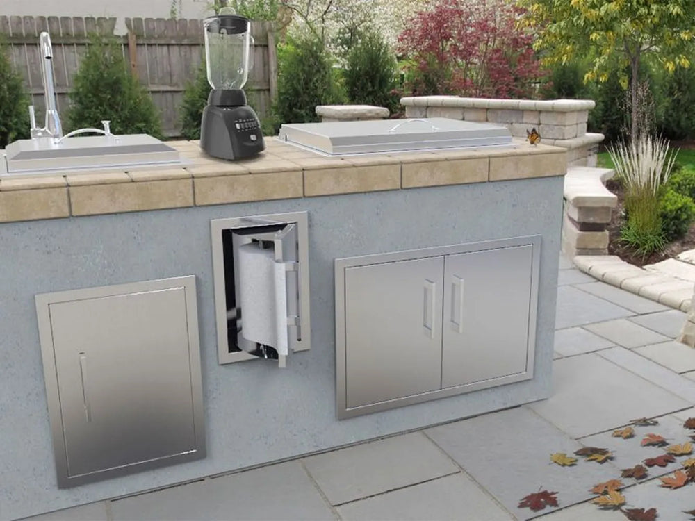 Sunstone BA-TH17 stainless swivel paper towel holder installed in outdoor kitchen island near sink and prep area, paper towels accessible.