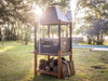 Tagwood BBQ BBQ02SI Santa Maria grill cooking over wood fire with hanging meat hooks