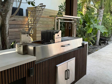 Tagwood BBQ08SS built-in Argentine open fire grill installed in outdoor kitchen island with Argentine grill clamp and Santa Maria system