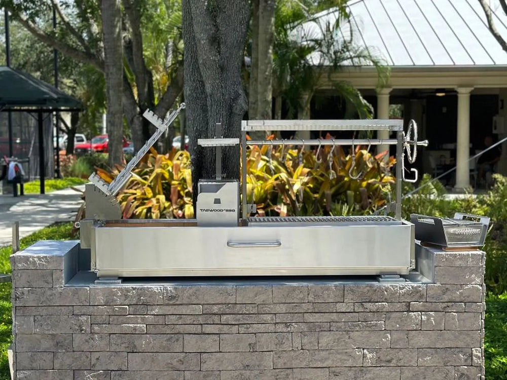 Tagwood BBQ08SS built-in Argentine open fire grill outdoor waterfront installation with Argentine clamp grill and adjustable grate