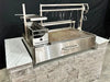Tagwood BBQ25SS XL built-in Santa Maria grill installed in outdoor masonry island with stainless grill system