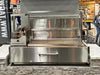 Tagwood BBQ25SS XL built-in Santa Maria grill live fire cooking at trade show booth with adjustable grate