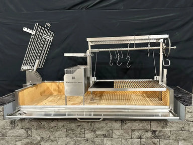 Tagwood BBQ28SS built-in Santa Maria grill installed in outdoor masonry island with adjustable crank grate and brasero firebox