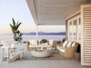 Bromic Platinum 3400W Electric Infrared Heaters mounted on a covered patio ceiling, seamlessly blending with the modern coastal decor featuring wicker seating, ocean views, and neutral tones.