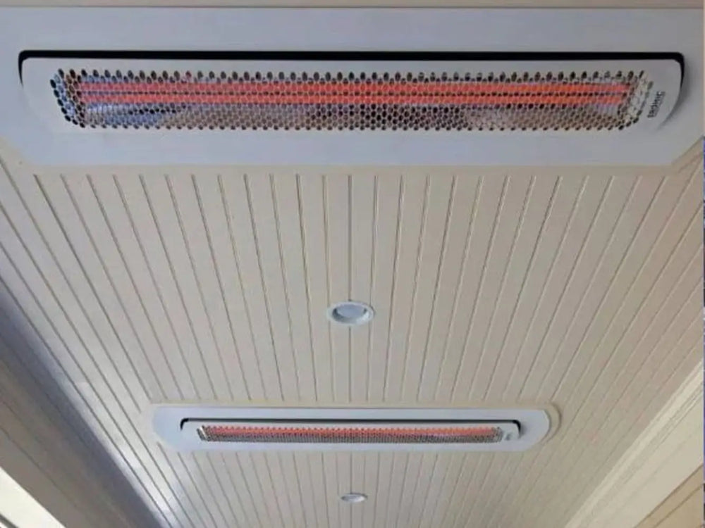 Flush-mounted Bromic Tungsten 6000W Heaters installed in a wood-paneled ceiling, delivering discreet and efficient heating coverage for covered outdoor areas.