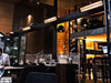 Bromic Smart-Heat black electric heaters installed on an overhead beam in a dark, upscale indoor bar.