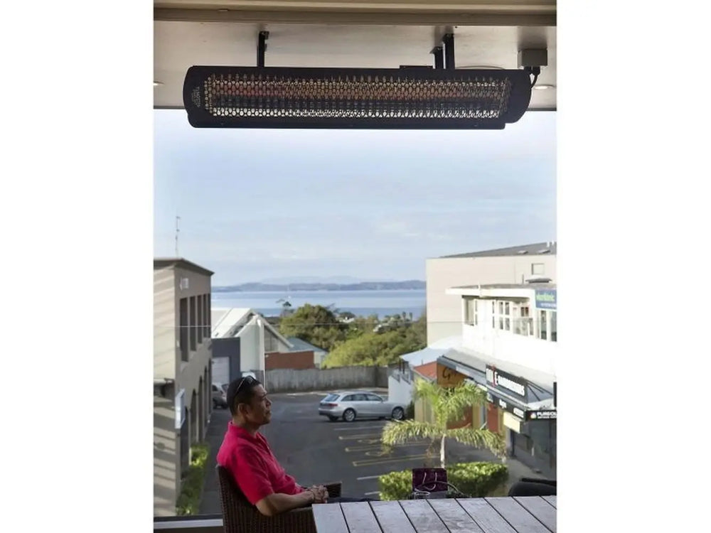 Single Bromic Smart-Heat electric outdoor heater ceiling-mounted on a residential balcony with a scenic view.