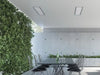 Two Bromic Platinum 4500W Electric Heaters recessed into a ceiling above a modern outdoor dining space with a living green wall and concrete walls.