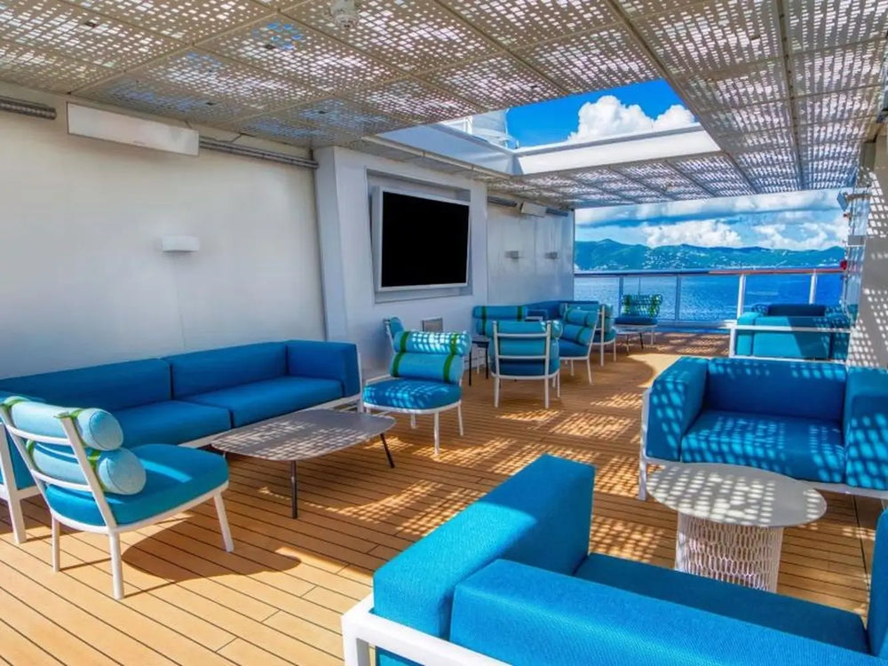 White Bromic Platinum 4500W Marine Heater installed on a yacht’s open deck, discreetly integrated above a vibrant lounge area with blue outdoor furniture.