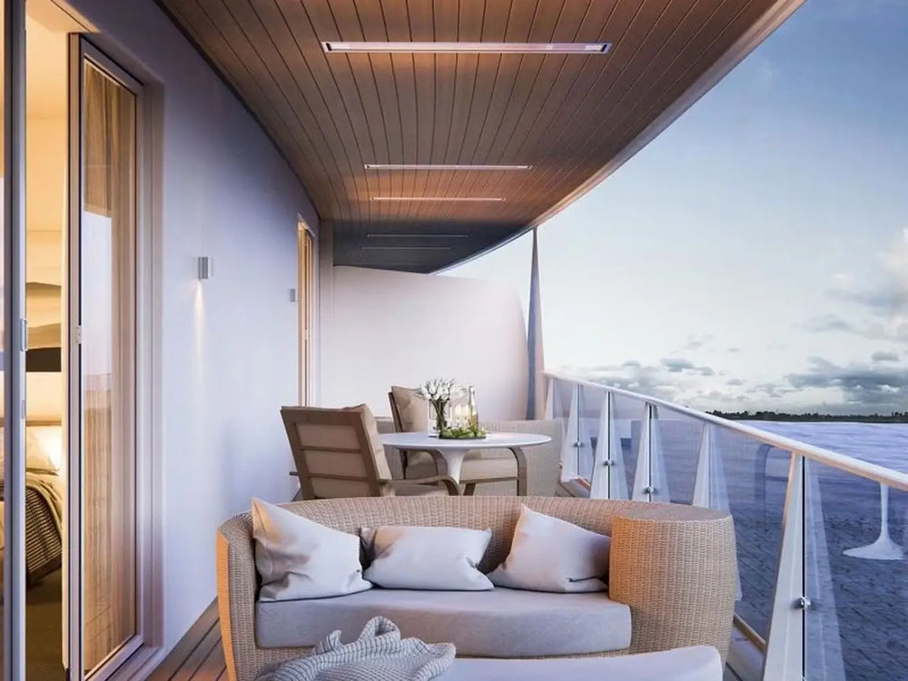 Bromic Platinum 4500W Marine Infrared Heaters installed on a modern curved balcony ceiling, providing seamless comfort with a view of the ocean horizon.