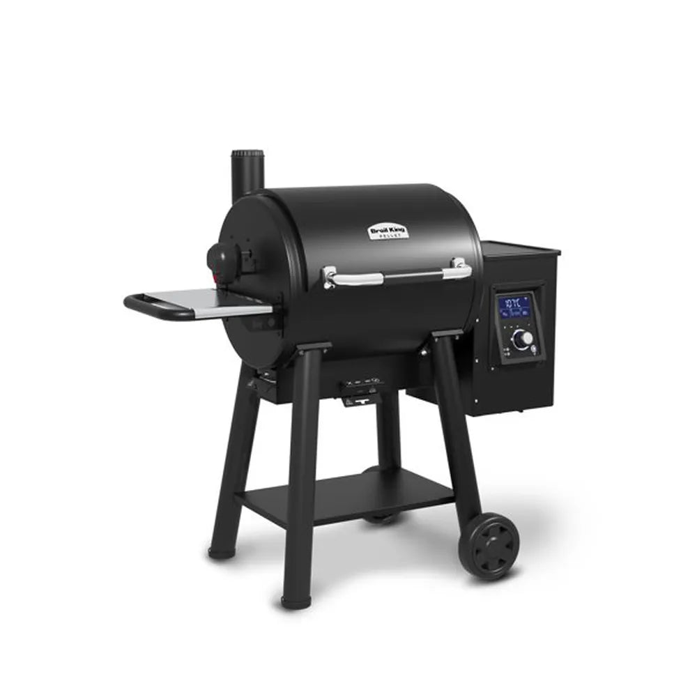 Angled product shot of the Broil King Regal Pellet 400 WiFi pellet grill with closed lid, highlighting the matte black finish, side handle shelf, pellet hopper control box, and compact freestanding frame.