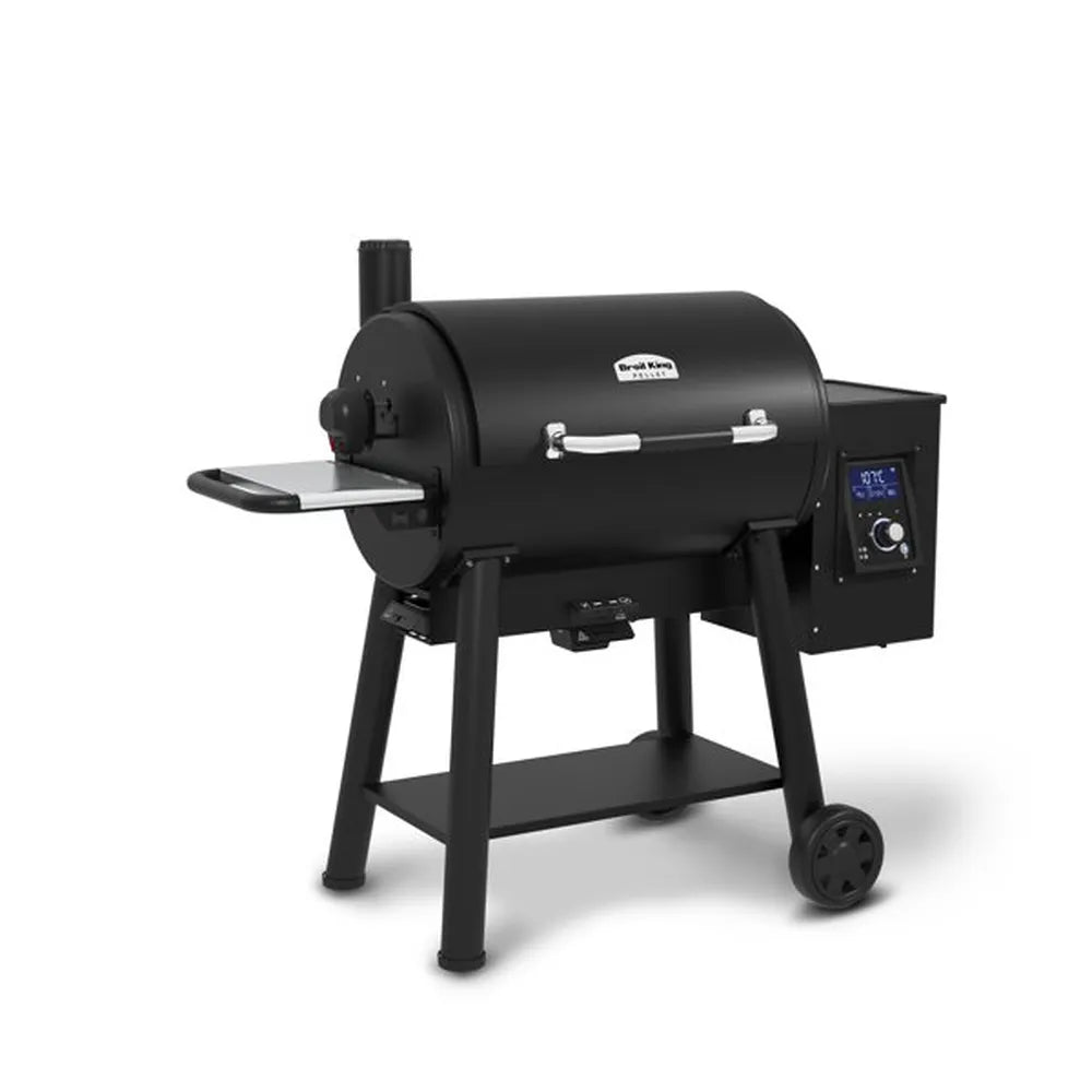 Broil King Regal Pellet 500 WiFi pellet grill product shot showing a black barrel-style pellet smoker with side shelf, digital control panel, storage shelf, and wheeled stand on a light gray background.