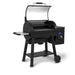 Broil King Regal Pellet 500 WiFi pellet grill with lid open, revealing the spacious pellet cooking chamber, upper warming rack, side shelf, digital controller, and black freestanding frame.