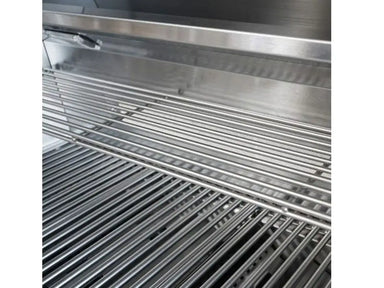 Grill interior with stainless steel cooking grates and elevated warming rack.