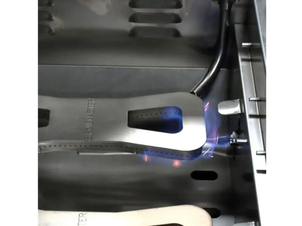 Close-up of the main cast stainless steel burner (H-style) lit with blue gas flames.