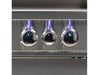 Close-up of three illuminated control knobs with blue LED lighting on the grill's front panel.