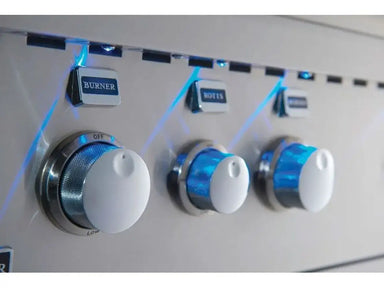 Illuminated Broilmaster gas grill control knobs with bright blue LED lighting for nighttime cooking.