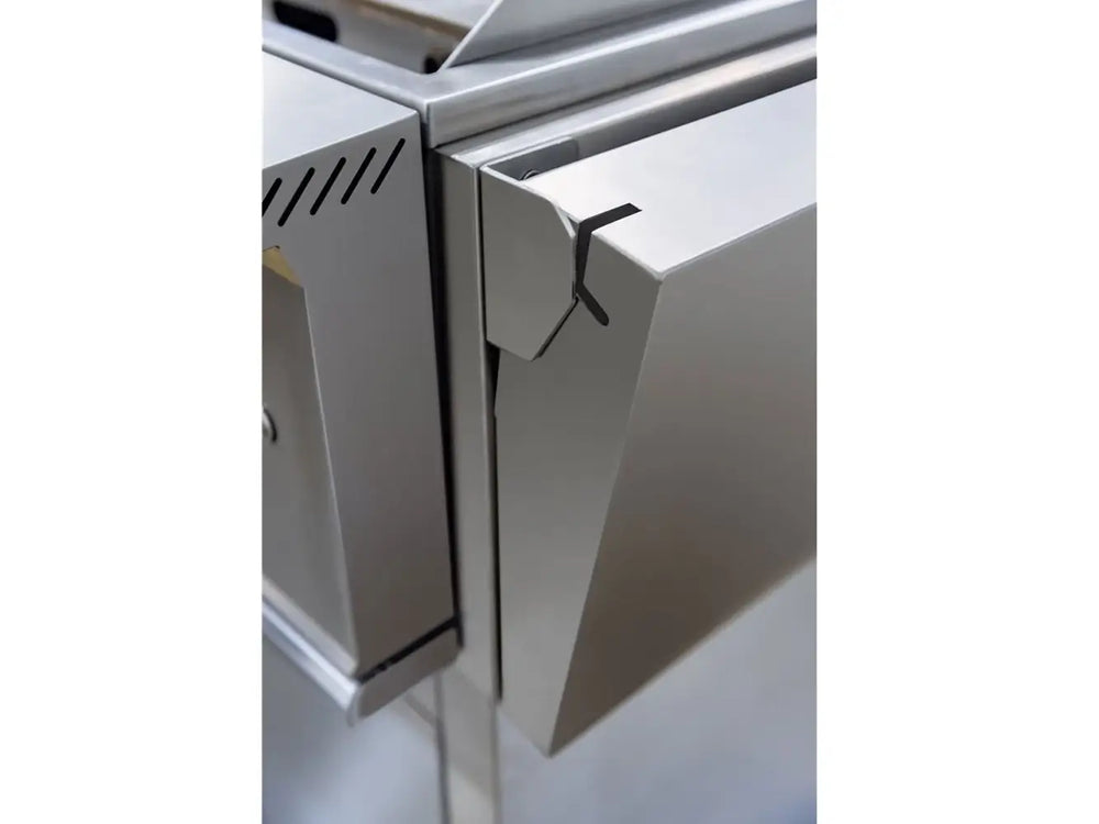 Close-up of True Flame griddle's side shelf with corner bracket detailing and stainless steel construction.