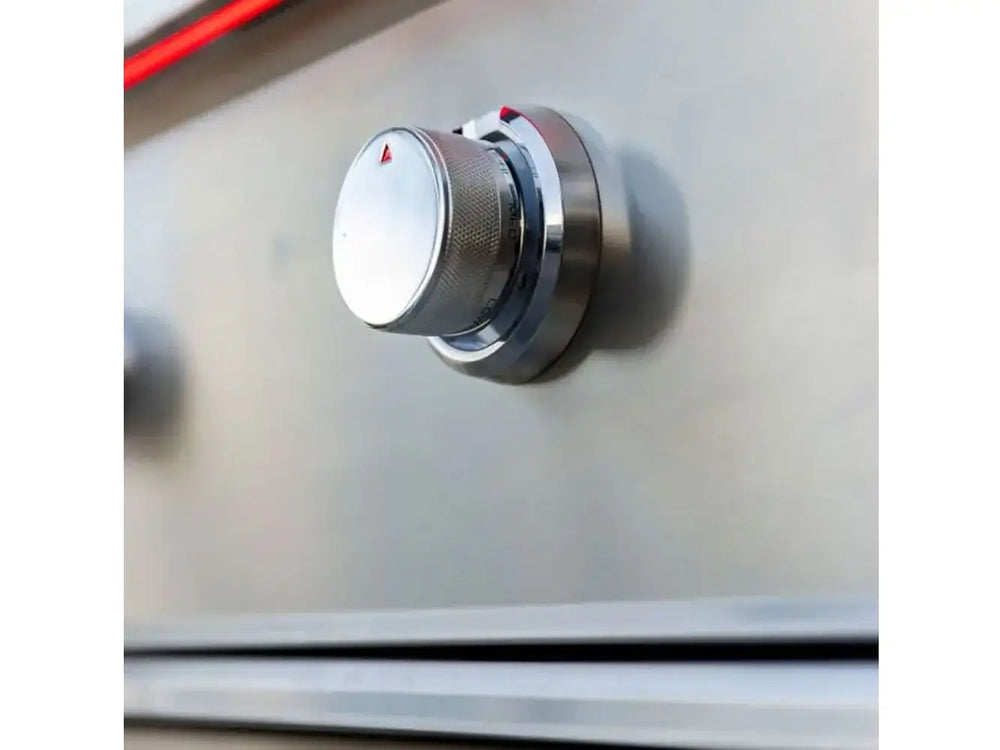 Stainless steel control knob on True Flame grill with red accent lighting, set against brushed metal surface.