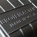 Close-up detail of the Broilmaster logo and 'Made in U.S.A.' text on the premium cast aluminum grill hood