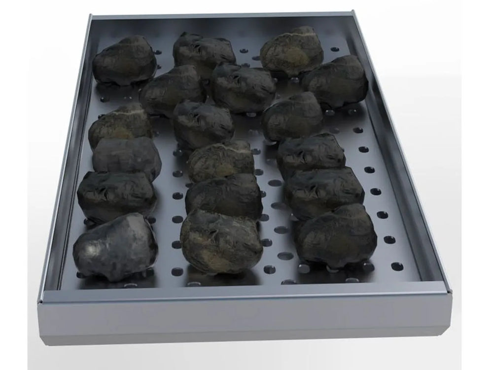 Sunstone charcoal smoking tray filled with charcoal briquettes on perforated panel, angled view on white background.
