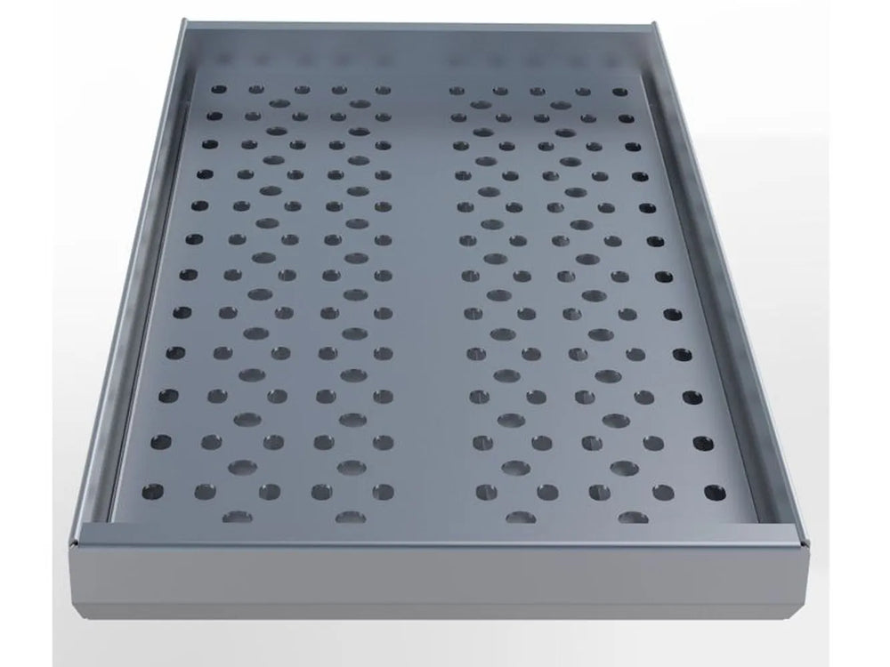 Angled view of Sunstone perforated charcoal tray insert with raised sidewalls and smooth front lip.