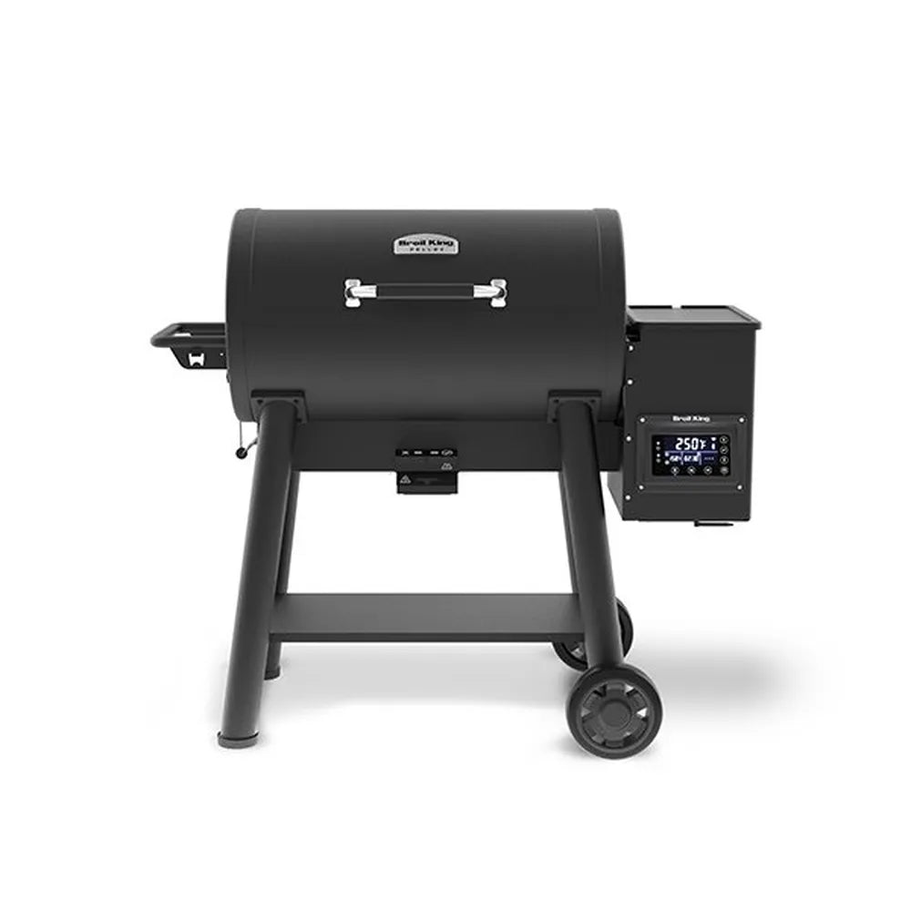 Front view of the Broil King Crown Pellet 500 WiFi pellet smoker in matte black, featuring a barrel-style cooking chamber, chrome handle, side pellet hopper with digital controller, small front shelf, lower support shelf, and two transport wheels on a light gray background.