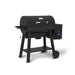 Angled product shot of the Broil King Crown Pellet 500 WiFi pellet smoker, highlighting the black barrel body, chrome lid handle, side-mounted digital control panel, front prep shelf, lower storage shelf, and rolling two-wheel design.