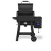 Broil King Crown Pellet 400 WiFi pellet smoker with lid raised, highlighting the spacious grilling interior, rear warming rack, digital control panel, side hopper, lower shelf, and freestanding black cart frame.