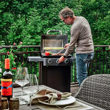 Broil King Crown 310 Shadow gas grill in use on backyard deck