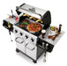 Broil King Regal S 420 Pro stainless gas grill open with food on grates, including pizza, steak, corn, and salad