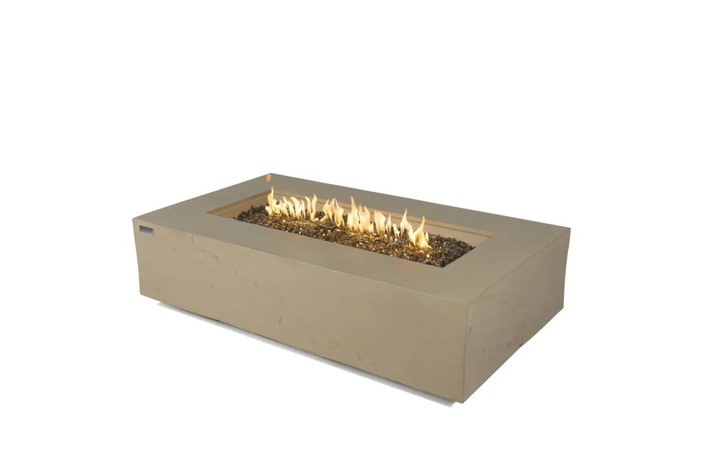 Studio product shot of the 60,000 BTU Elementi Plus Colorado sunlight yellow fire table on a white background, featuring a lit linear flame and natural volcanic lava rocks.