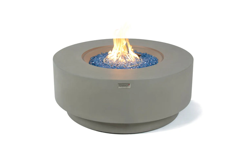 Elementi Plus Colosseo OFG414LG light gray round fire table with blue fire glass and flame.
