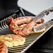 Close-up of sausages and grilled pineapple on Broil King Regal S 690 Pro IR dual-oven grill warming rack