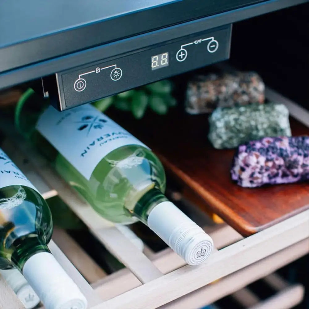Close-up of Summerset RFR-24W digital controls and wood shelf with white wine bottles.