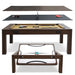 An exploded product view of the Freetime Fun Transformer 7-foot 4-in-1 multi-game table in an espresso finish, showcasing the convertible layers including the dining table top, ping-pong surface, tan felt billiard pool table, and the rotating air hockey table base.