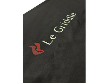 Close-up of the Le Griddle logo embroidered on the durable black  protective fabric cover.