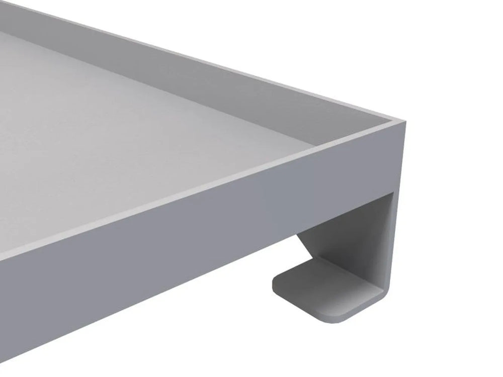 Close-up of Sunstone griddle corner showing stainless lip and mounting tab/foot for secure placement.