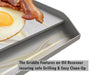 Close-up of griddle oil/grease reservoir with cooked egg and bacon, showing drip control for easier cleanup.