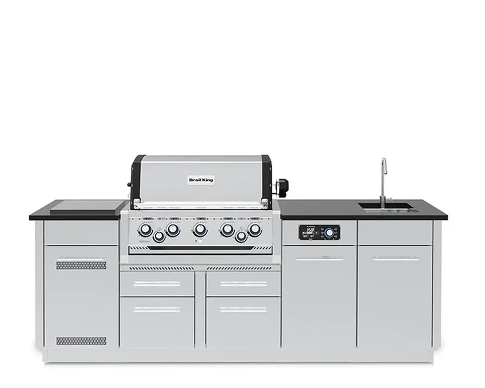 A direct front view of the fully assembled Broil King Imperial QS 590iE Smart Grill Island on a pure white background, showcasing the central built-in gas grill, control panel, sink, and side cabinets.